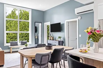 a dining room with blue walls and a table and chairs at Scenic Riverstone 2BR w/ Balcony + BBQ, Sleeps 6! in Golden