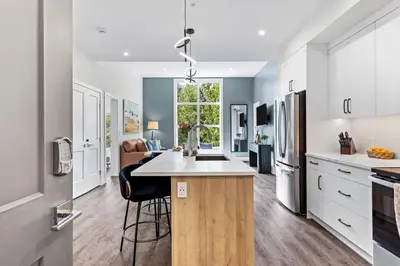 a kitchen with a island in the middle of a room at Scenic Riverstone 2BR w/ Balcony + BBQ, Sleeps 6! in Golden