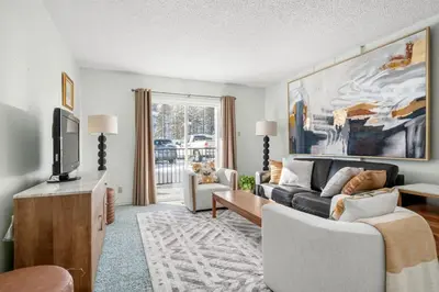 a living room with a couch and a tv at Charming 1BR Near DT Kimberley: Pool, Hot Tub, Gym in Kimberley