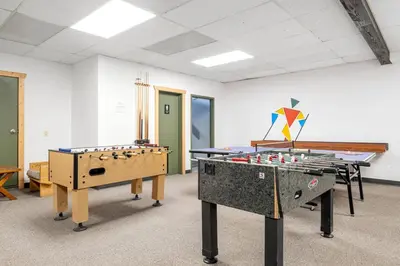 a room with two ping pong tables and a kite at Charming 1BR Near DT Kimberley: Pool, Hot Tub, Gym in Kimberley