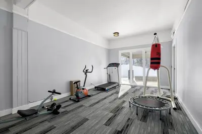 a gym with several exercise equipment in a room at Charming 1BR Near DT Kimberley: Pool, Hot Tub, Gym in Kimberley