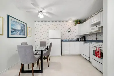 a kitchen with a table and chairs and a refrigerator at Kimberley Escape: 1BR+Studio w/ Hot Tub, Pool, BBQ in Kimberley