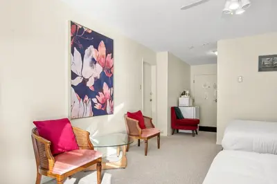 a bedroom with a bed and two chairs and a table at Kimberley Escape: 1BR+Studio w/ Hot Tub, Pool, BBQ in Kimberley