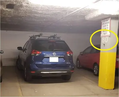 a car is parked in a parking garage at Stylish DT Condo ~2 Blocks from Stampede Grounds in Calgary