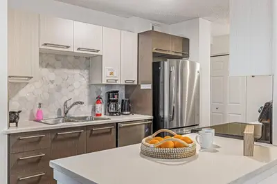 a kitchen with a bowl of oranges on a counter at Stampede Modern downtown Condo Spacious 2BR in Calgary
