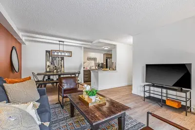 a living room with a couch and a tv at Stampede Modern downtown Condo Spacious 2BR in Calgary