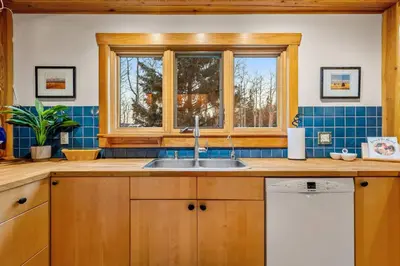 a kitchen with a sink and a window at Highlands Homestead Luxury Retreat in Bragg Creek