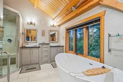 a large bathroom with a tub and a shower at Highlands Homestead Luxury Retreat in Bragg Creek