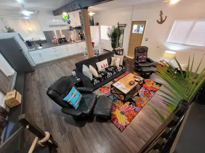 an overhead view of a living room with a couch and chairs at Nesting Ravens cottage in Nanaimo