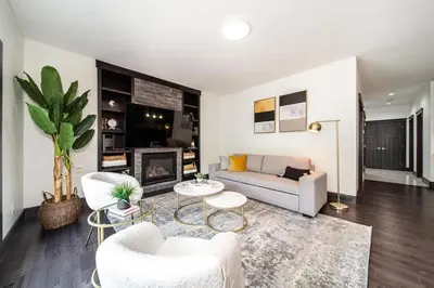 a living room with a couch and chairs and a fireplace at Luxury Sleeps 10 King bed Jacuzzi 10 Min to West Edmonton Mall in Edmonton