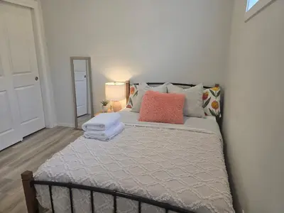 a bedroom with a large bed with pillows on it at Amaville Suites - One Bedroom in West Edmonton in Edmonton