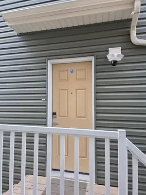 a door on the side of a house at Amaville Suites - One Bedroom in West Edmonton in Edmonton