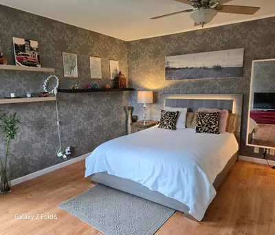 a bedroom with a large white bed in a room at Wallace getaway in Delta