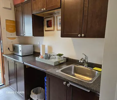 a kitchen with a sink and a microwave at Wallace getaway in Delta