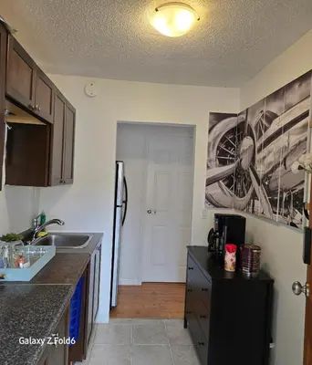 a kitchen with a sink and a refrigerator at Wallace getaway in Delta