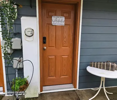 a wooden door of a house with a sign on it at Wallace getaway in Delta