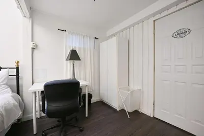 a bedroom with a bed and a desk and a chair at Vancouver UBC 2BD Suite in Vancouver