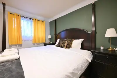 a bedroom with a large bed and a window at Vancouver UBC 2BD Suite in Vancouver