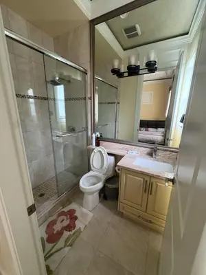 a bathroom with a shower and a toilet and a sink at Sweet Graceful Home Queen size bedroom for 2 Guests in Richmond