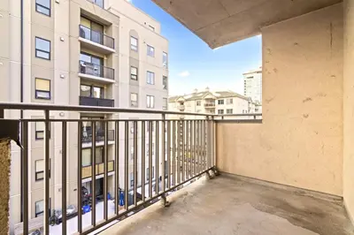 a balcony in a building with a balcony railing at Bright 2 Bedroom Suite at Victoria & Stampede Park in Calgary