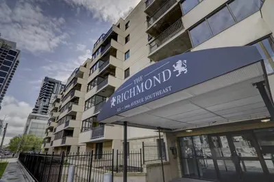a building with a sign in front of it at Bright 2 Bedroom Suite at Victoria & Stampede Park in Calgary