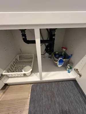 a kitchen under a counter with a sink at Northside Dream Home in Edmonton