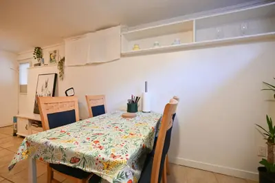 a dining room table with a flowered table cloth at Basement Suite in South Vancouver in Vancouver