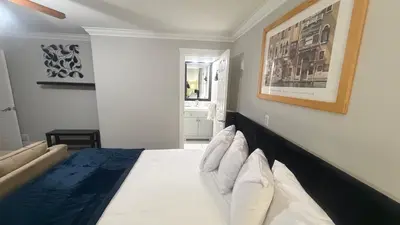 a bedroom with a bed with white sheets and pillows at J & J Dream Villa Ltd in Abbotsford