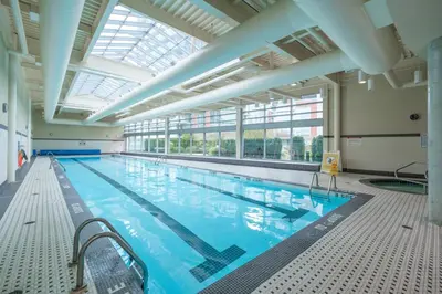 a large indoor swimming pool with a large ceiling at Cozy Condo in Prime Location with Jacuzzi Pool & Sauna in Vancouver
