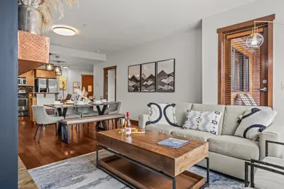 a living room with a couch and a table at Heart of Canmore Condo managed by Little Sister Getaways in Canmore