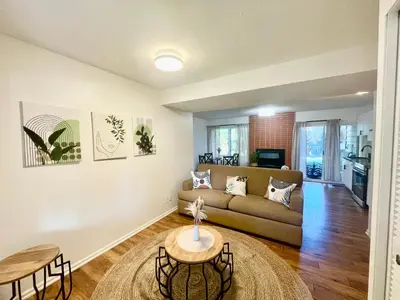 a living room with a couch and a table at AK Stay in Abbotsford