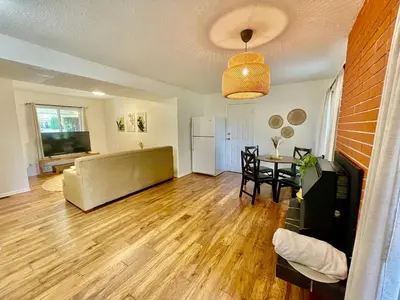 a living room with a couch and a table at AK Stay in Abbotsford