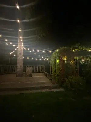 a lit up patio with a light pole and lights at AK Stay in Abbotsford
