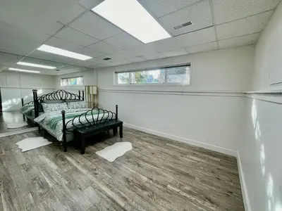 an empty room with a bed and a window at AK Stay in Abbotsford