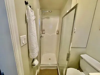 a bathroom with a shower with a glass door at AK Stay in Abbotsford