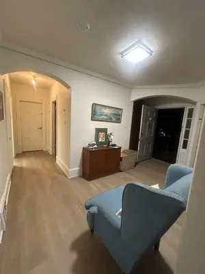 a living room with a blue chair and a couch at Airport Vancouver Private Rooms - Transit at Doorstep, Free Parking & Fast Wi-Fi in Vancouver