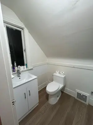 a white bathroom with a toilet and a sink at Airport Vancouver Private Rooms - Transit at Doorstep, Free Parking & Fast Wi-Fi in Vancouver