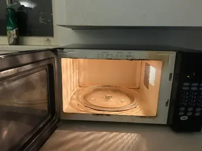 a microwave with its door open in a kitchen at Airport Vancouver Private Rooms - Transit at Doorstep, Free Parking & Fast Wi-Fi in Vancouver
