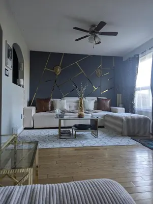 a living room with a couch and a ceiling fan at The Love Home Stay in Edmonton