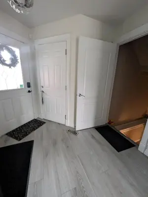 an empty room with two white doors and a window at The Love Home Stay in Edmonton