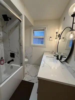 a bathroom with a sink and a tub and a shower at Downtown Vancouver Rooms - Walk to SkyTrain & BC Place, Free Parking & Fast Wi-Fi in Vancouver