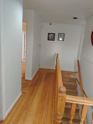 an empty hallway with a staircase in a house at Vancouver Private Rooms - Free Parking, Fast Wi-Fi, Easy Transit - 15 mins Downtown & 11 mins Airport in Vancouver