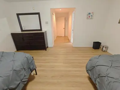 a room with a wooden floor and a dresser at Vancouver Private Rooms - Free Parking, Fast Wi-Fi, Easy Transit - 15 mins Downtown & 11 mins Airport in Vancouver