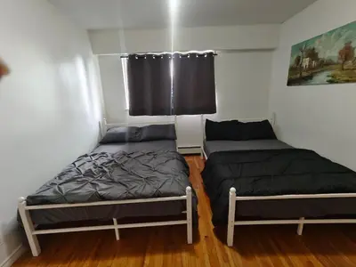 a bedroom with two beds and a window at Vancouver Private Rooms - Free Parking, Fast Wi-Fi, Easy Transit - 15 mins Downtown & 11 mins Airport in Vancouver