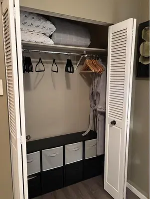 a walk in closet with a bed and clothes at Sweet Home in Aldergrove