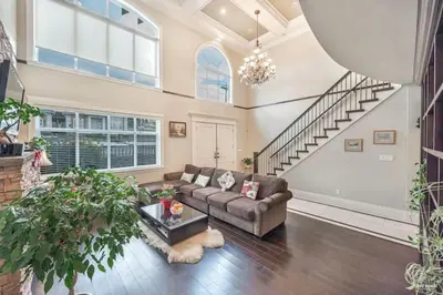a living room with a couch and a staircase at Vancouver Burnaby Villa 44 in Burnaby