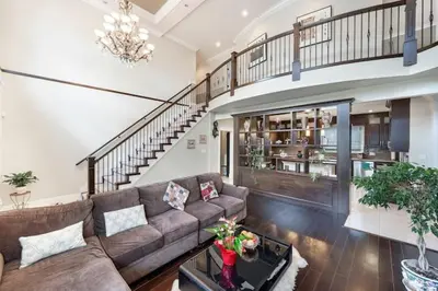 a living room with a couch and a staircase at Vancouver Burnaby Villa 44 in Burnaby