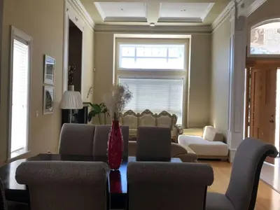 a living room with a couch and a table and chairs at Vancouver Richmond Villa43 in Richmond