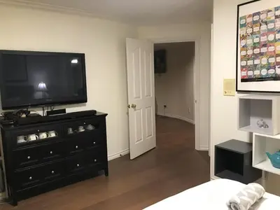 a living room with a flat screen tv on a dresser at Vancouver Richmond Villa43 in Richmond