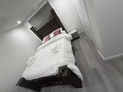 an overhead view of a bed in a bedroom at Brand New 1 Bedroom Basement Suite in Southwest in Edmonton
